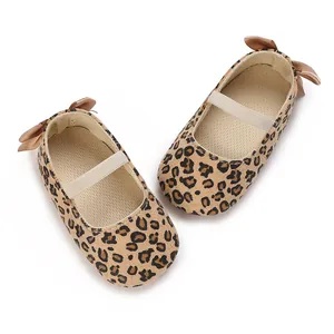 Top-down view of leopard print baby ballet flats with satin bow and elastic strap