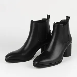 Elegant black leather Chelsea boots featuring a stable block heel and square toe.