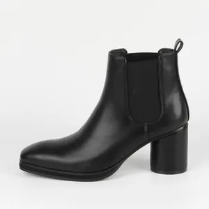 Detailed side view of a black leather Chelsea boot featuring a chunky block heel.