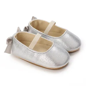 Close-up of silver glitter baby Mary Jane shoes with back bow and soft non-slip sole