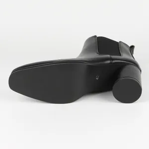 Detailed view of black men's leather Chelsea boot sole and heel with size 42 marking