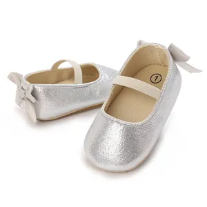 Detailed macro shot of silver glittery baby girl shoes featuring a decorative heel bow