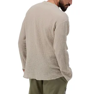 Detailed back view of men's loose fit seersucker long sleeve shirt in beige color