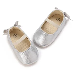 Elegant silver glitter infant Mary Jane shoes featuring a soft sole and grey bow accent