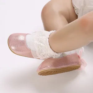 Detailed view of pink glitter baby shoes with lace ruffles and non-slip soft sole