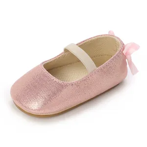 Detailed view of pink glitter baby Mary Jane shoes with soft sole and ribbon bow