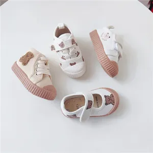 Top view of children's cartoon bear canvas shoes with soft brown soles
