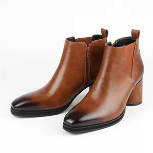 Detailed view of brown leather Chelsea boots with side zipper and chunky block heel.