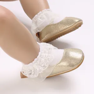 Close-up detail of golden glitter baby Mary Jane shoes featuring elegant white lace ruffles