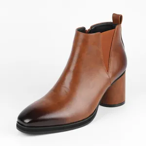 Stylish men's brown Chelsea boots featuring a chunky high heel and elastic side panel