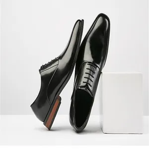 Detail shot of black leather oxford shoes with stylish wooden heel and glossy finish.