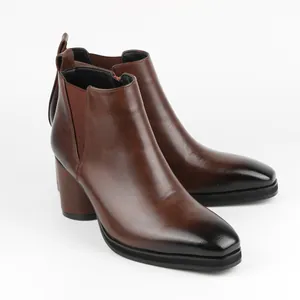 Side view of brown burnished leather Chelsea boots with chunky high heel and zipper