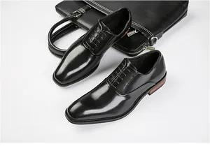 Detail of black genuine leather Oxford shoes for men with elegant wood accented heels