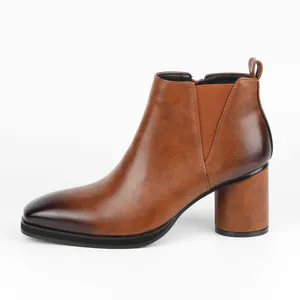 Side view of men's brown burnished high-heeled Chelsea boots with elastic panel
