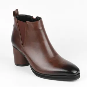 Side detail of brown men's Chelsea boots featuring a burnished toe and high block heel design