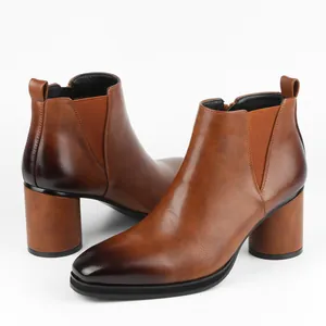 Close-up of brown leather men's Chelsea boots with block heel and burnished toe finish