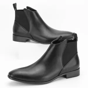 High-quality side profile of black leather Chelsea boots with elastic side panels.
