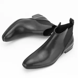 Detailed side and top view of classic black leather Chelsea boots for men on white background