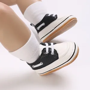 Stylish black and white lace-up infant walking shoes for babies aged zero to one year