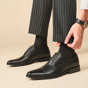 Chaussures richelieu classiques en cuir noir à bout rapporté pour costume d'affaires