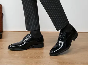 Detailed side view of black patent leather cap-toe Oxford shoes for formal business wear.