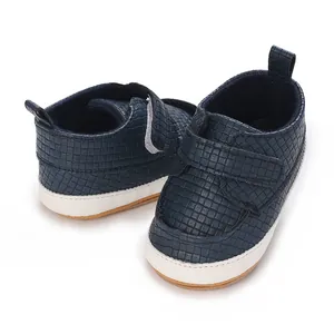 Dettaglio scarpe primi passi blu navy per neonati con trama intrecciata e chiusura velcro