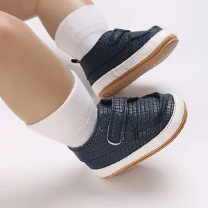 Dettaglio di scarpe da neonato blu navy in tessuto con pratica chiusura a strappo