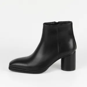 Side view of a sleek black leather ankle boot with high block heel and side zipper