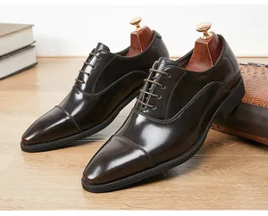 Detailed view of dark brown leather oxford shoes with triple-seam toe and elegant gloss finish
