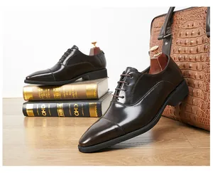 Close-up of classic brown leather Oxford shoes with polished finish and pointed toe.