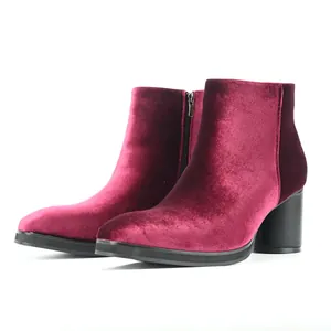 Detailed side view of premium burgundy velvet ankle boots with chunky black high heel.