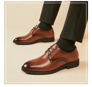 Close-up detail of classic brown leather business dress shoes with brogue wingtip patterns