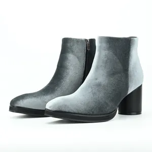 Detailed side view of elegant grey velvet ankle boots with chunky block heels and zipper