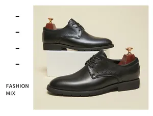 Close-up detail of men's premium black leather business dress shoes with brogue accents