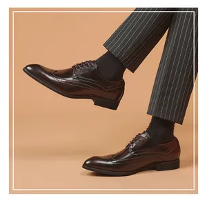 Detailed side view of dark brown wingtip brogue dress shoes worn with pinstripe trousers