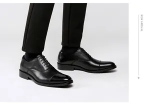 Macro detail of men's genuine black leather cap-toe oxford shoes for formal business