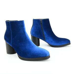 Side view of elegant blue velvet ankle boots with block heel and side zipper