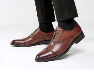 Close-up of brown leather cap-toe oxford shoes for men in a formal setting