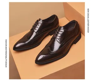 Glossy mahogany pointed toe brogue dress shoes displayed on a warm beige pedestal