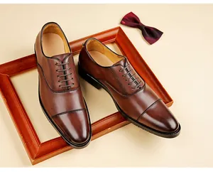 Macro detail of classic brown leather oxfords featuring elegant cap-toe stitching