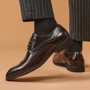 Classic men's polished dark brown brogue shoes with wingtip detailing for business formal wear