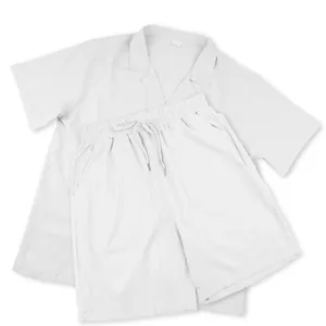 Detailed macro view of a light grey short-sleeve button-down shirt and matching shorts set