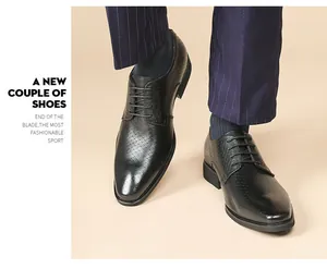 Close-up of black embossed leather Derby shoes worn with pinstripe trousers.