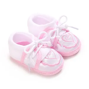 Detailed macro view of pink and white baby anti-slip floor socks featuring heart embroidery