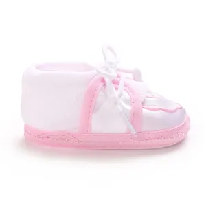 Side view of pink and white baby floor sock with bow and anti-slip sole detail
