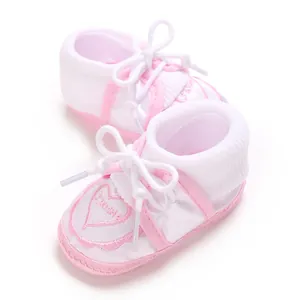 Detailed view of baby non-slip floor socks featuring pink heart embroidery and soft laces.