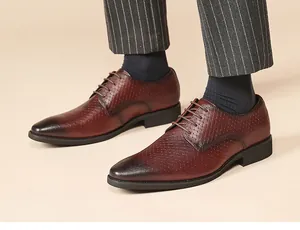 Detail of men's brown leather Derby shoes with embossed texture and lace-up design