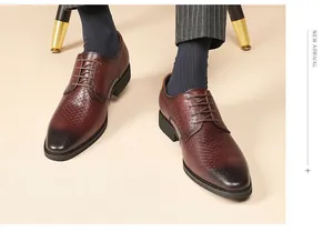 Detailed view of men's embossed brown leather Derby shoes for formal business attire.