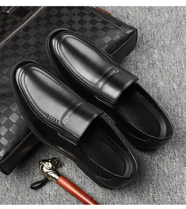 Classic black leather business loafers for men on textured background