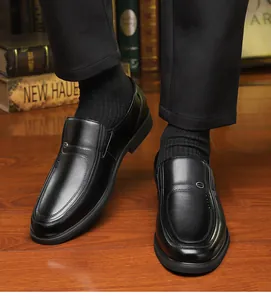 Detail shot of men's genuine black leather business shoes with a slip-on design.
